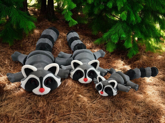 Close-up of details on 3D printed raccoon figures including facial features and texture